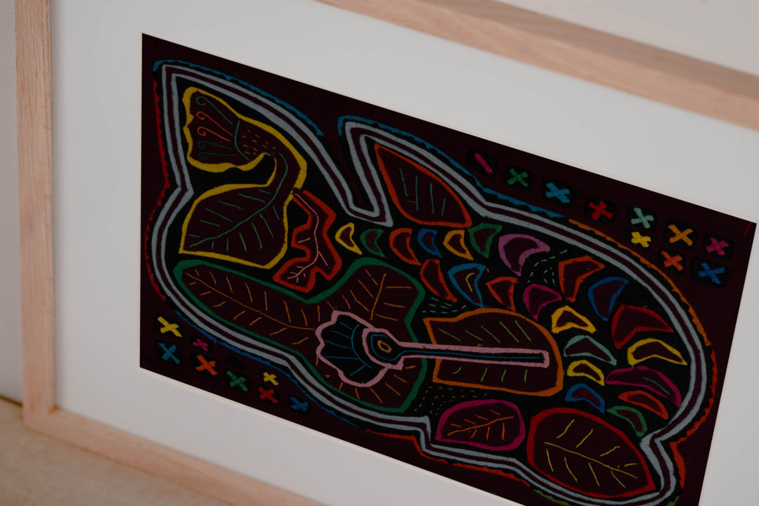 Hand stitched Guna mola from Guna Yala Panama, gray and white outline winding around the design