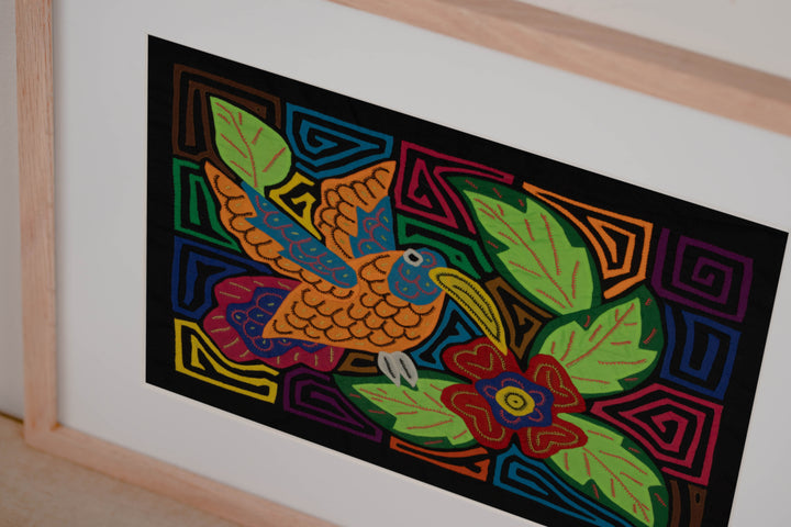 Colorful Hummingbird Feeding on Flower Mola