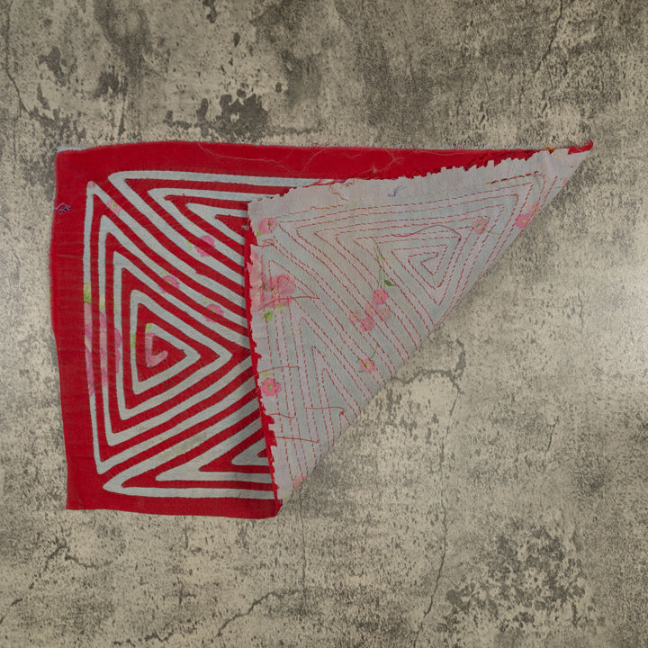 Hand stitched Guna mola from Guna Yala Panama, red channels over gray cloth with pink roses