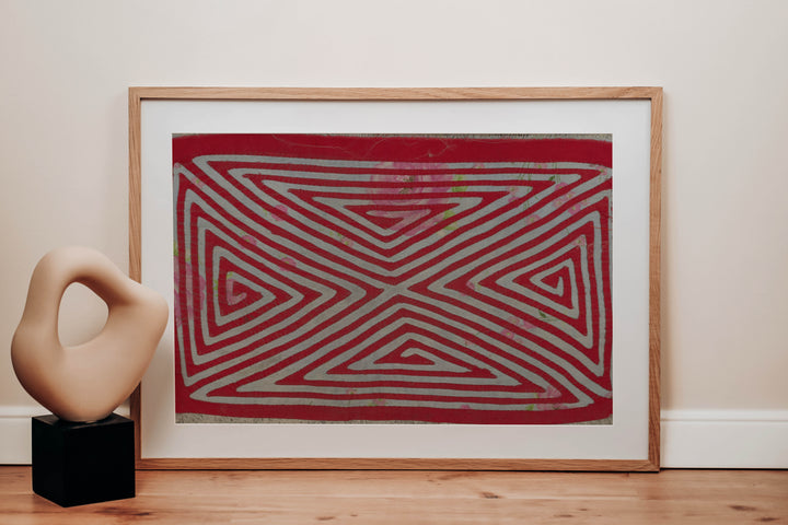 Panama mola panel, nested triangles meeting in an X over rose print cloth, hand stitched reverse applique