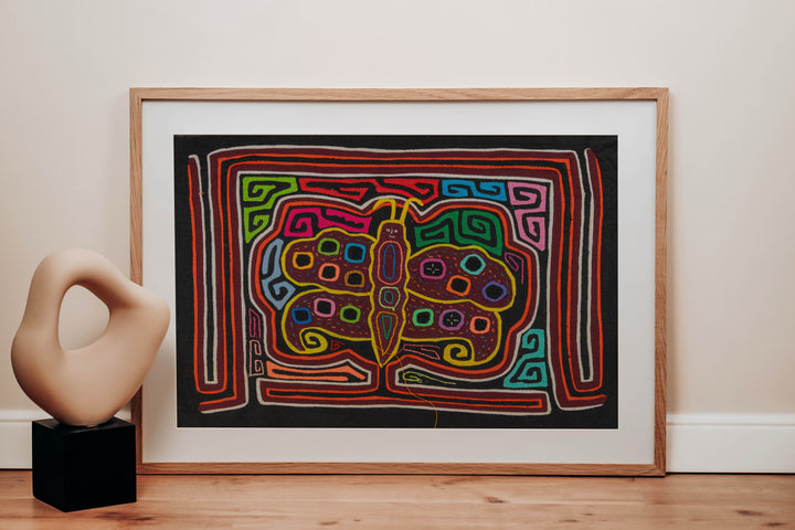 Panama mola panel, butterfly with polka dot wings and a smiling face on black, hand stitched reverse applique