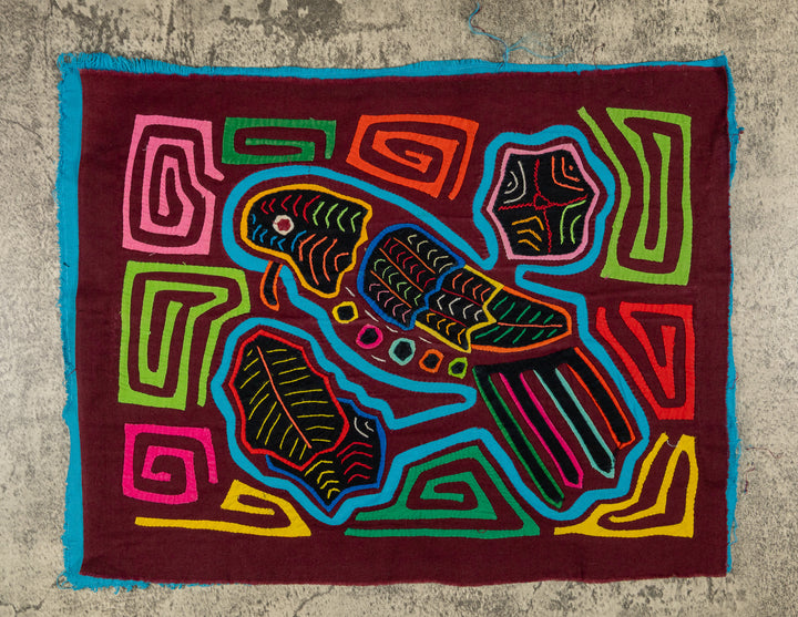 Panama mola panel, turquoise parrot with a tiny beak and striped tail on maroon, hand stitched reverse applique