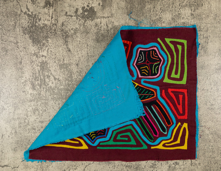 Hand stitched Guna mola from Guna Yala Panama, leaves around the perched parrot