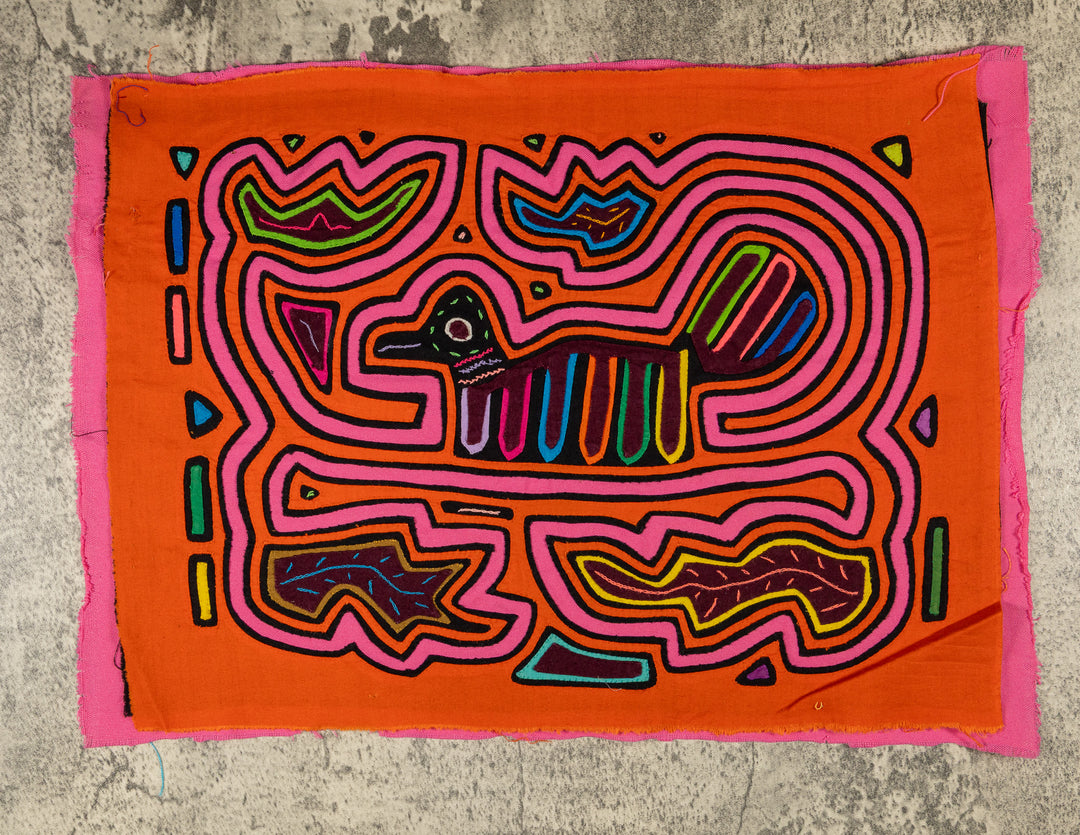 Panama mola panel, small duck shaped bird with a striped tail in a pink maze on orange, hand stitched reverse applique