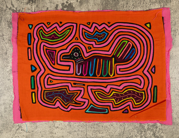 Panama mola panel, small duck shaped bird with a striped tail in a pink maze on orange, hand stitched reverse applique