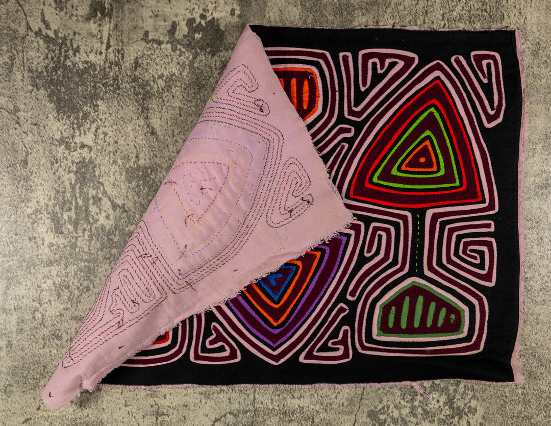 Hand stitched Guna mola from Guna Yala Panama, pink maze channels around the spade shapes