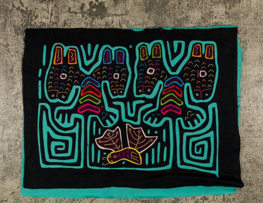 Panama mola panel, four heads with tall ears above a leafy bird on black, hand stitched reverse applique