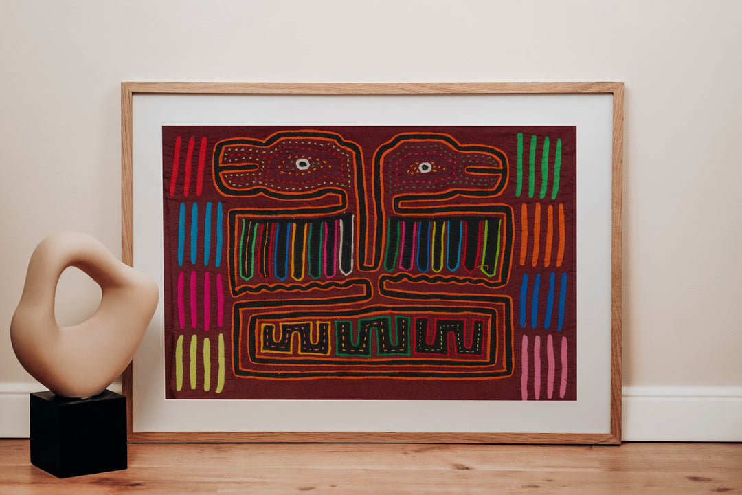 Panama mola panel, double headed thunderbird with striped wings on maroon, hand stitched reverse applique