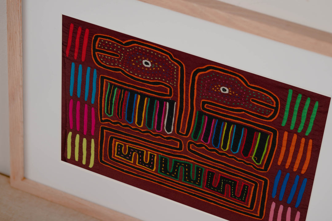 Hand stitched Guna mola from Guna Yala Panama, orange tracing on the hooked bills