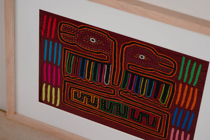 Hand stitched Guna mola from Guna Yala Panama, orange tracing on the hooked bills