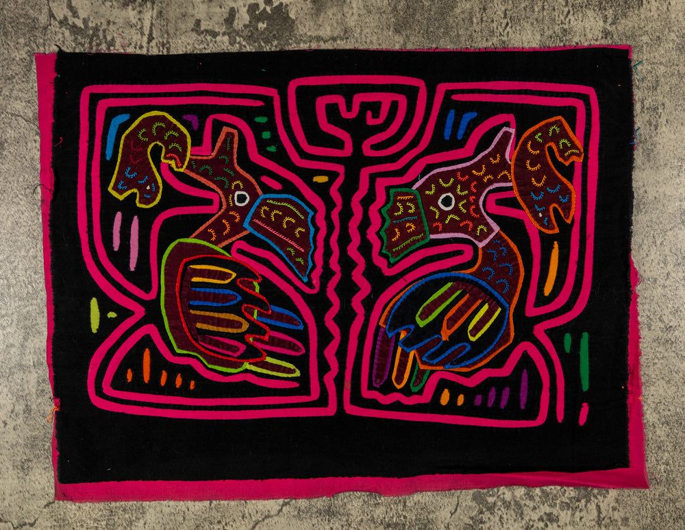 Panama mola panel, two long billed birds each holding a fish in a pink maze on black, hand stitched reverse applique