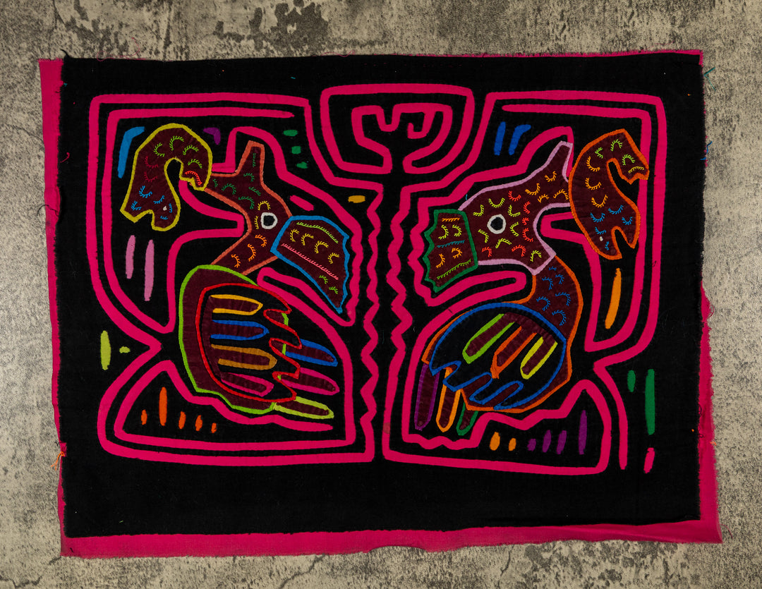 Panama mola panel, two long billed birds each holding a fish in a pink maze on black, hand stitched reverse applique