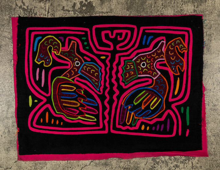 Panama mola panel, two long billed birds each holding a fish in a pink maze on black, hand stitched reverse applique