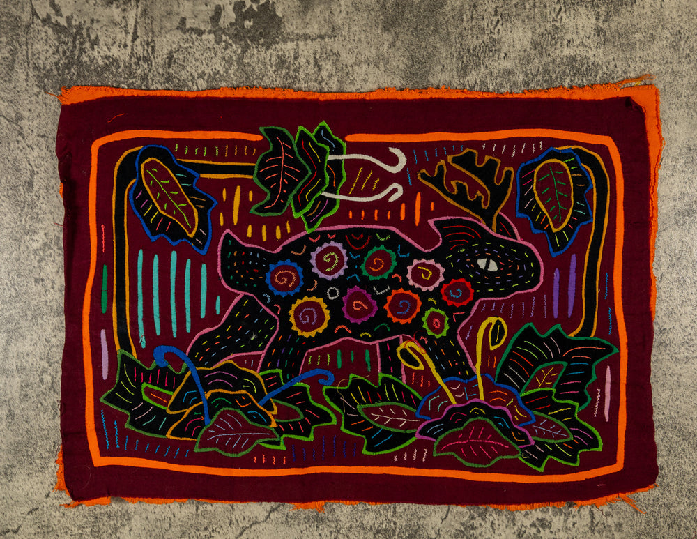 Panama mola panel, small animal with spiral spots among leaves on maroon, hand stitched reverse applique