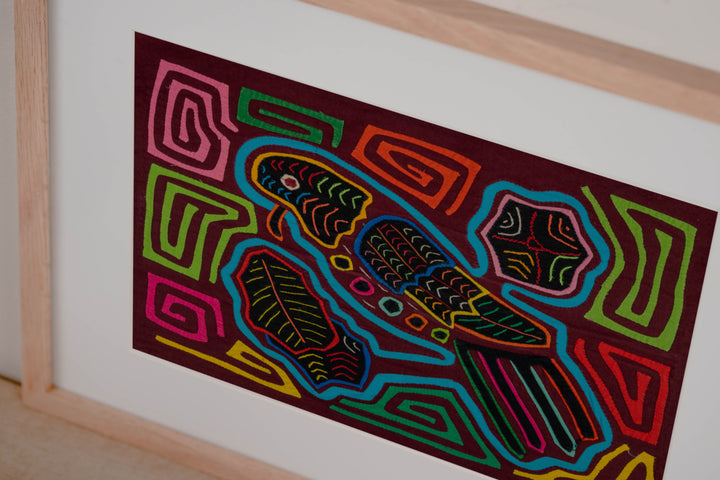 Hand stitched Guna mola from Guna Yala Panama, leaves around the perched parrot