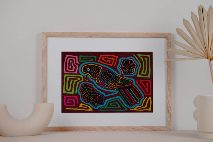 Panama mola panel, turquoise parrot with a tiny beak and striped tail on maroon, hand stitched reverse applique