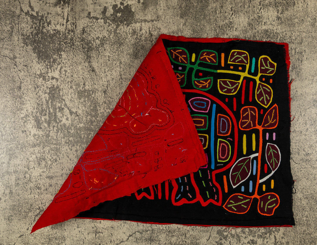 Hand stitched Guna mola from Guna Yala Panama, red outlines on the spots and leaves