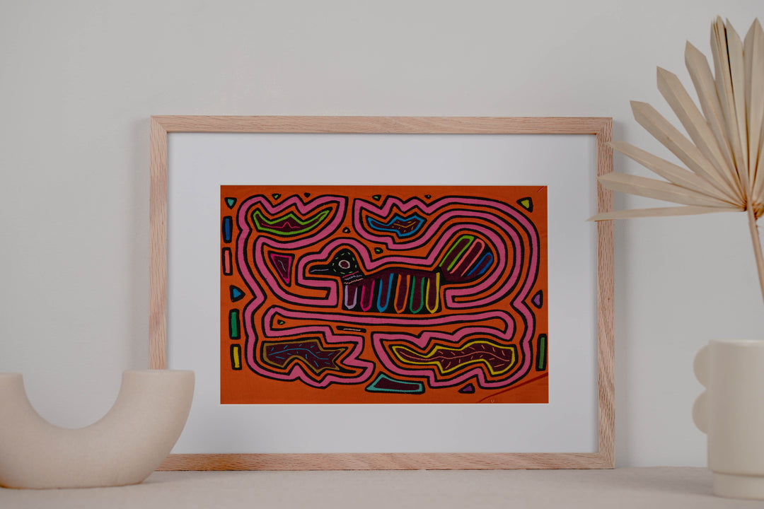 Panama mola panel, small duck shaped bird with a striped tail in a pink maze on orange, hand stitched reverse applique