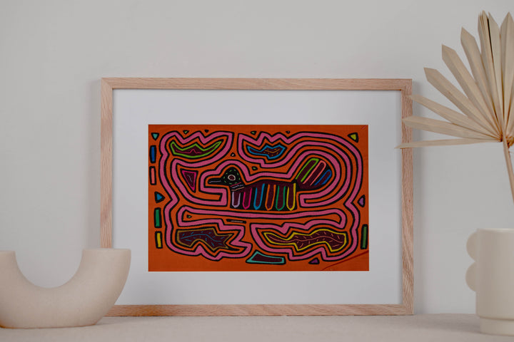 Panama mola panel, small duck shaped bird with a striped tail in a pink maze on orange, hand stitched reverse applique