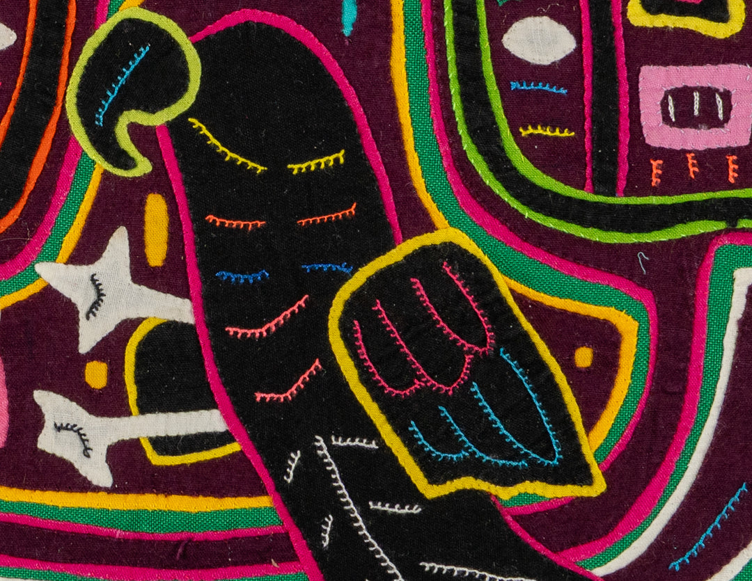 Faces with a parrot mola, hand stitched Guna panel from Panama, 14 by 12.5 inches