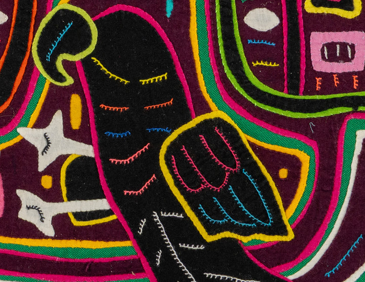Faces with a parrot mola, hand stitched Guna panel from Panama, 14 by 12.5 inches