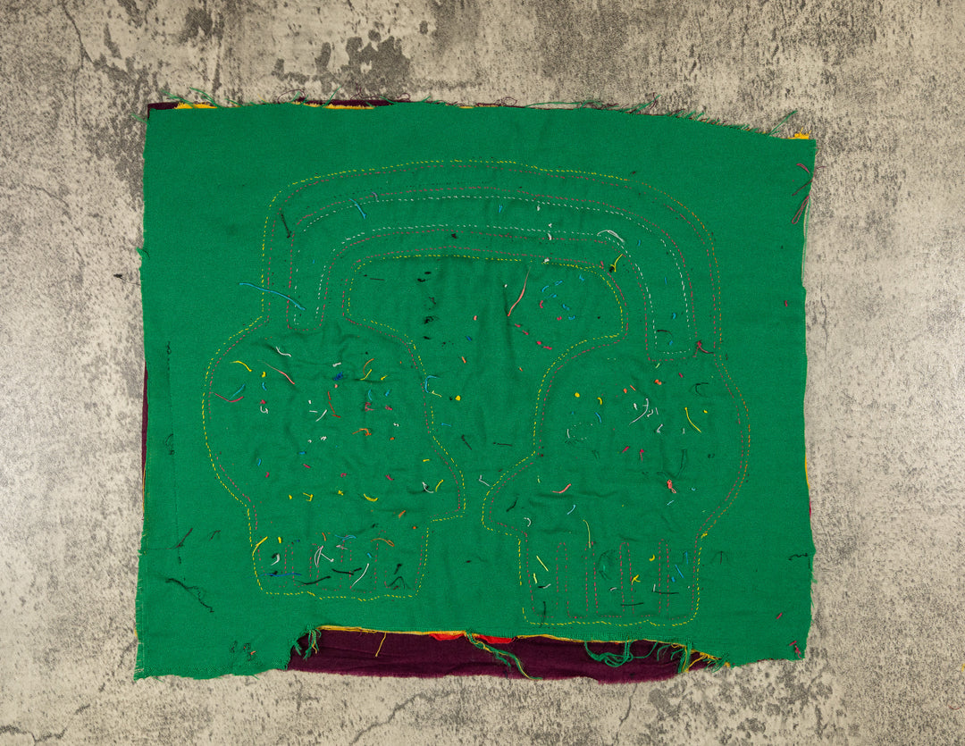 Faces with a parrot mola, hand stitched Guna panel from Panama, 14 by 12.5 inches