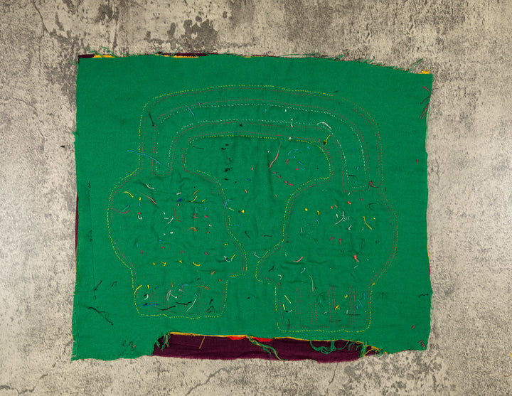 Faces with a parrot mola, hand stitched Guna panel from Panama, 14 by 12.5 inches
