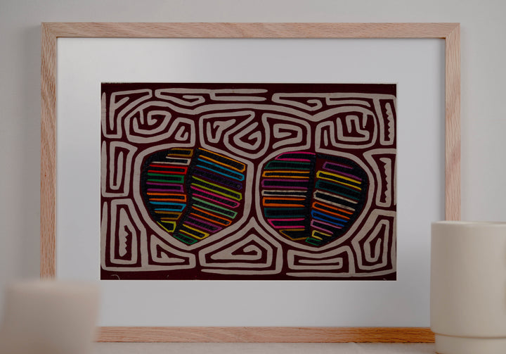 Panama mola panel, two striped fruit shapes in a white maze on maroon, hand stitched reverse applique