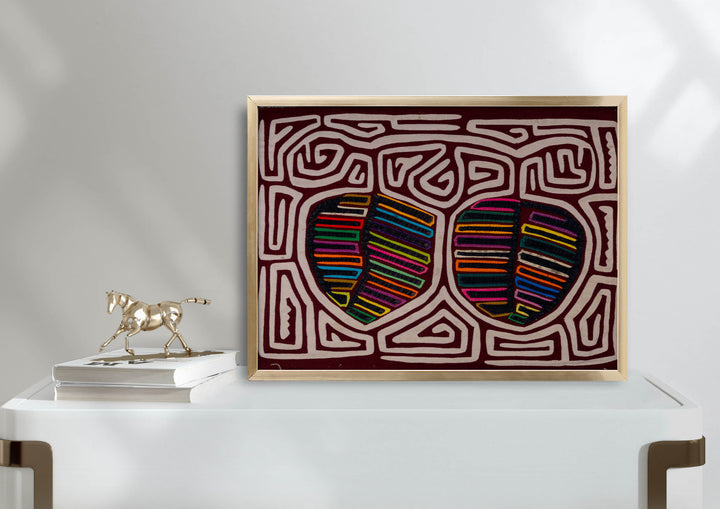 Panama mola panel, two striped fruit shapes in a white maze on maroon, hand stitched reverse applique