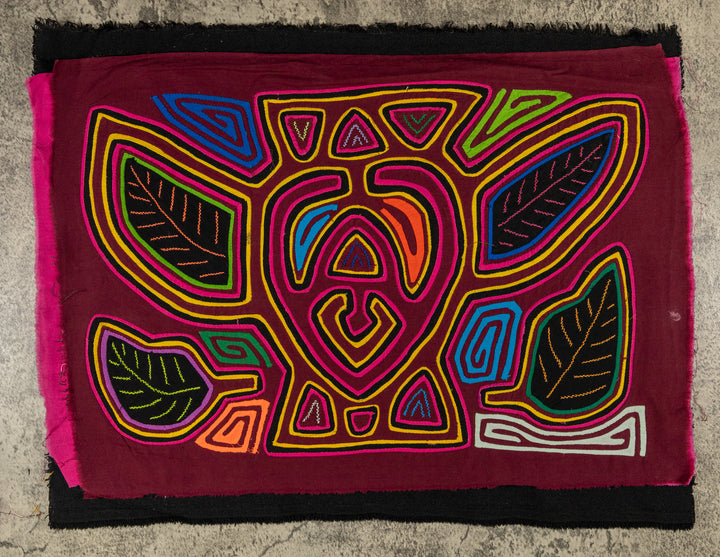 Panama mola panel, a plump bumblebee among leaves on maroon, hand stitched reverse applique