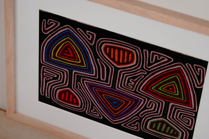 Hand stitched Guna mola from Guna Yala Panama, pink maze channels around the spade shapes