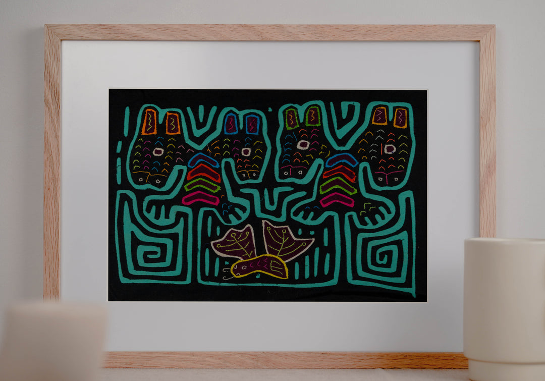 Panama mola panel, four heads with tall ears above a leafy bird on black, hand stitched reverse applique