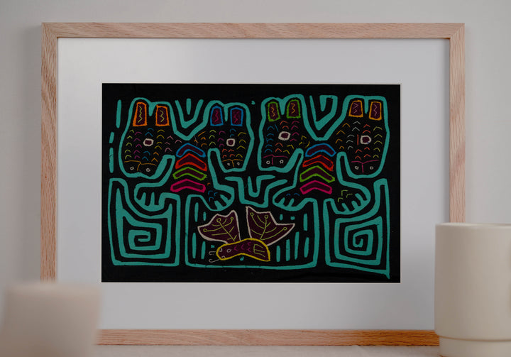 Panama mola panel, four heads with tall ears above a leafy bird on black, hand stitched reverse applique