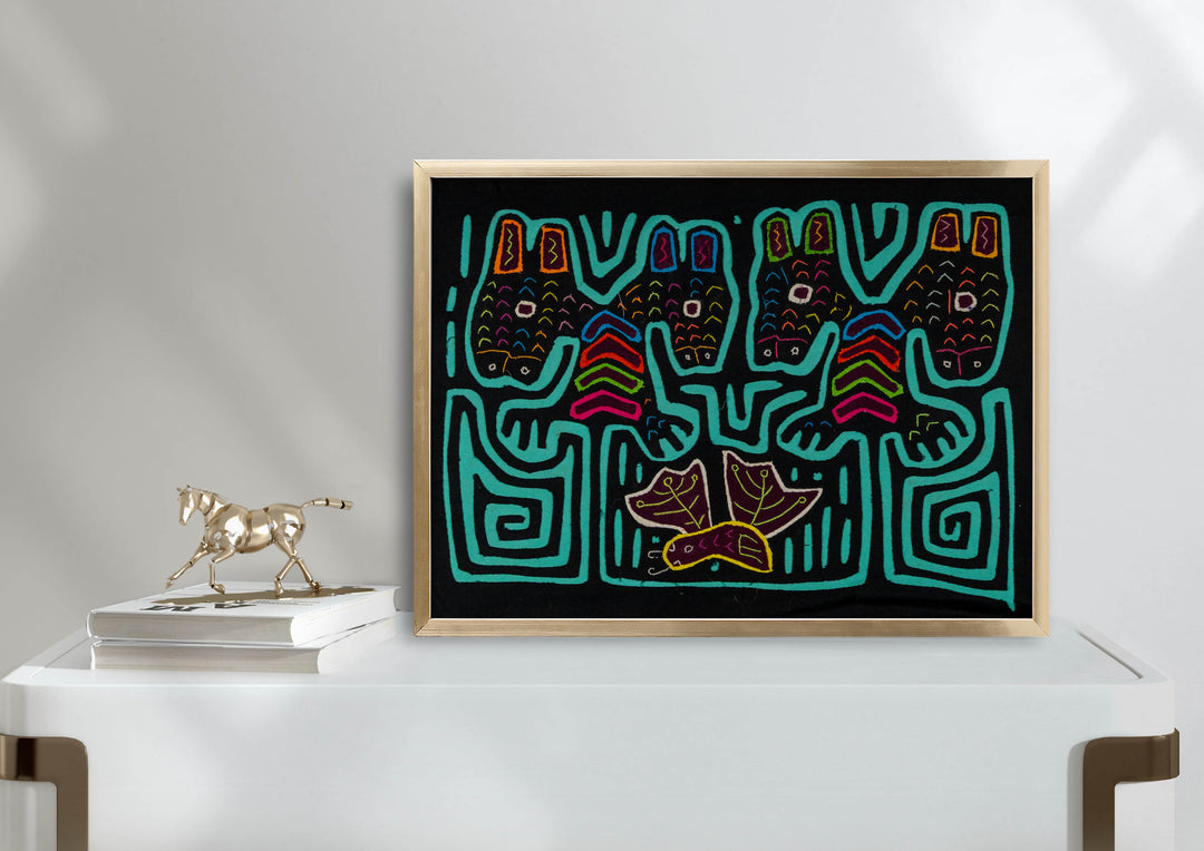 Panama mola panel, four heads with tall ears above a leafy bird on black, hand stitched reverse applique