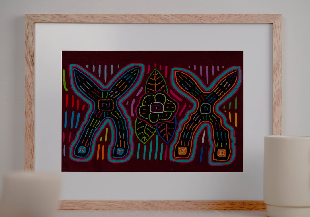 Panama mola panel, two big crossed shapes with a flower and leaves on maroon, hand stitched reverse applique