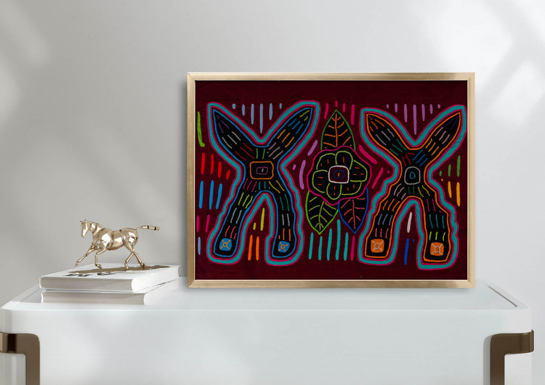 Panama mola panel, two big crossed shapes with a flower and leaves on maroon, hand stitched reverse applique
