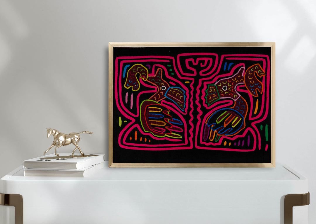 Panama mola panel, two long billed birds each holding a fish in a pink maze on black, hand stitched reverse applique