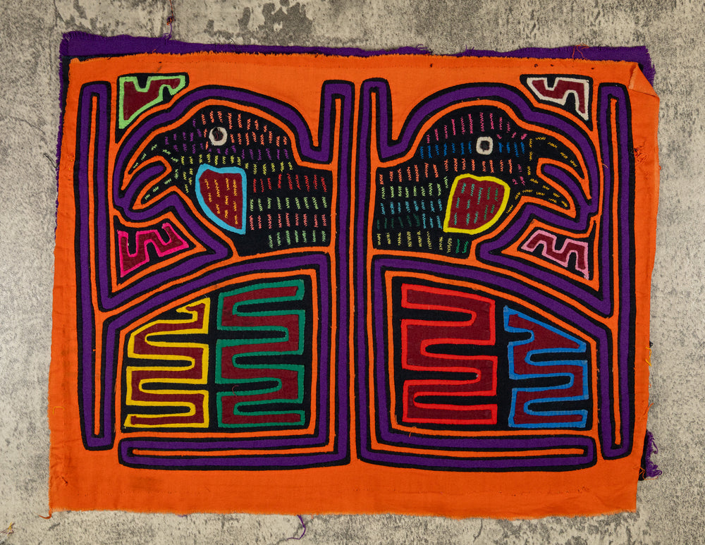 Panama mola panel, two hook billed birds in separate frames on orange, hand stitched reverse applique