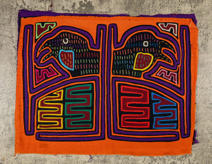 Panama mola panel, two hook billed birds in separate frames on orange, hand stitched reverse applique