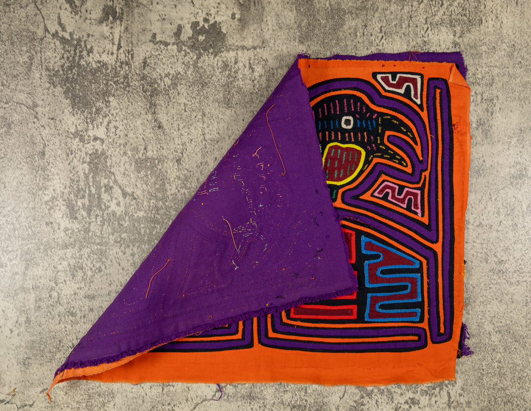 Hand stitched Guna mola from Guna Yala Panama, purple outlines on the frames and the birds