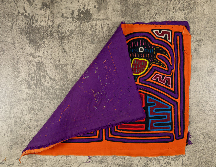 Hand stitched Guna mola from Guna Yala Panama, purple outlines on the frames and the birds