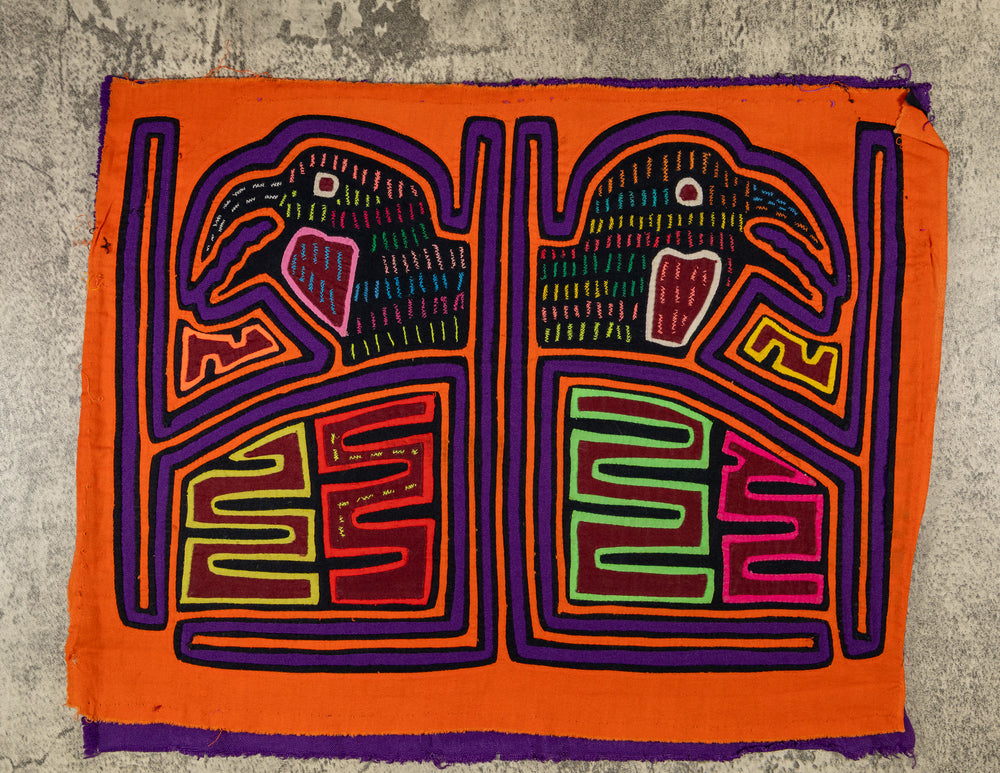 Panama mola panel, pair of hook billed birds in a framed cage on orange, hand stitched reverse applique
