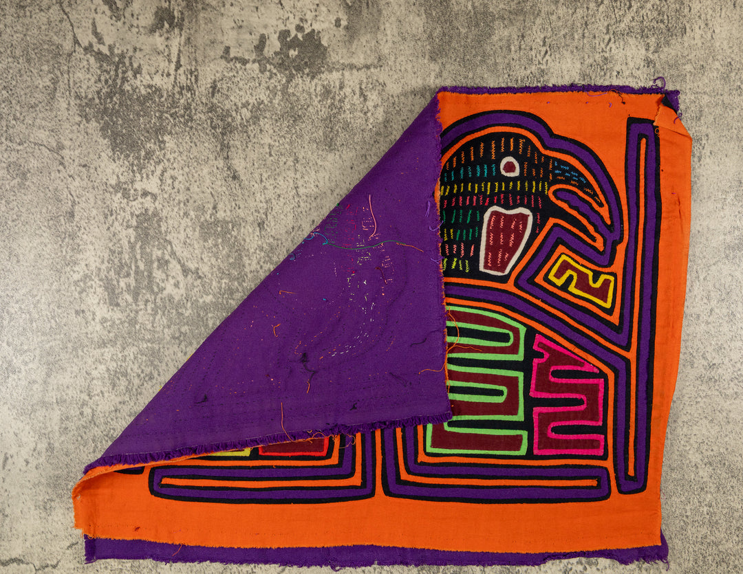 Hand stitched Guna mola from Guna Yala Panama, purple tracing around the cage