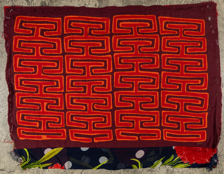 Panama mola panel, allover orange key pattern on red with a flowered strip, hand stitched reverse applique