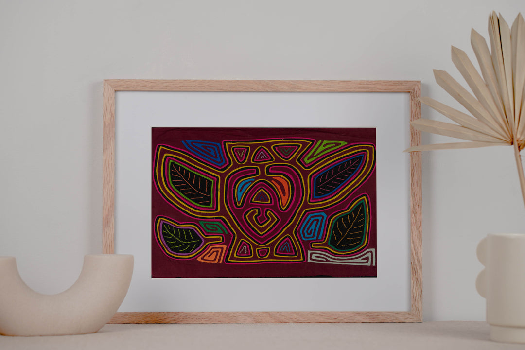 Panama mola panel, a plump bumblebee among leaves on maroon, hand stitched reverse applique