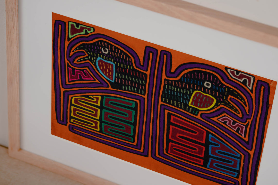 Hand stitched Guna mola from Guna Yala Panama, purple outlines on the frames and the birds