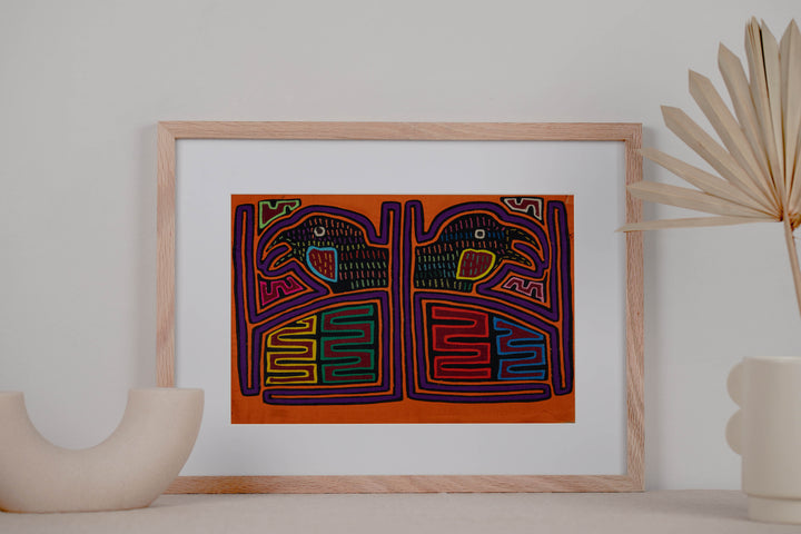 Panama mola panel, two hook billed birds in separate frames on orange, hand stitched reverse applique