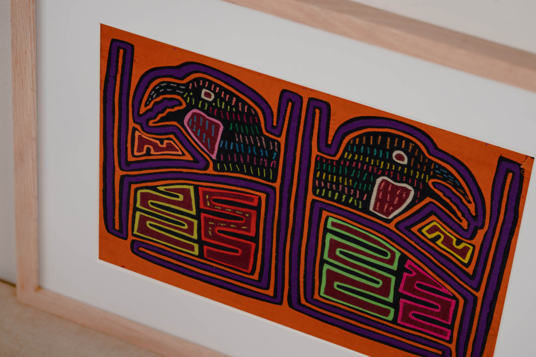 Hand stitched Guna mola from Guna Yala Panama, purple tracing around the cage