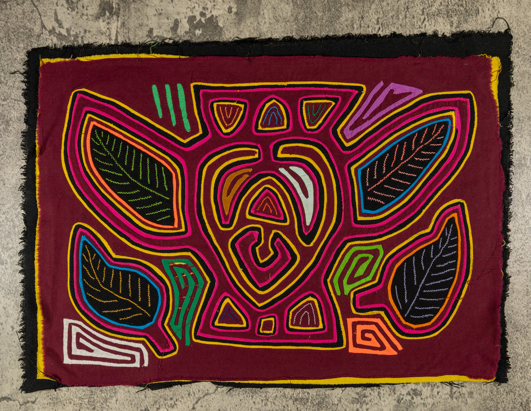 Panama mola panel, bumblebee shape with leaf wings outlined in pink on maroon, hand stitched reverse applique