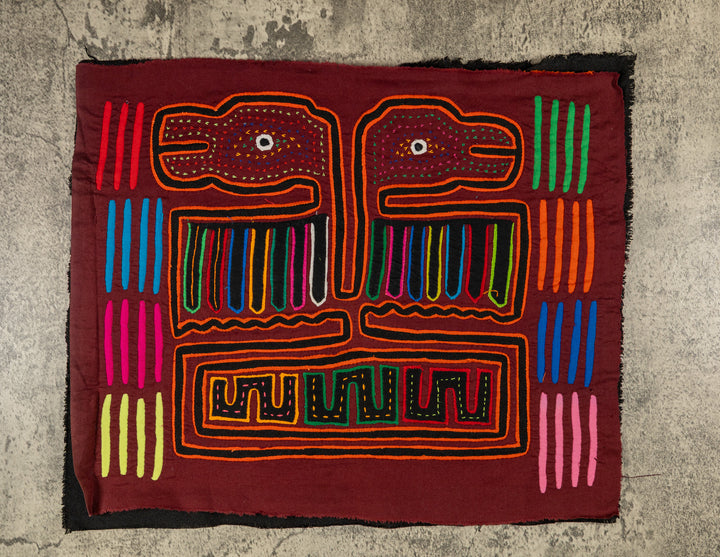 Panama mola panel, double headed thunderbird with striped wings on maroon, hand stitched reverse applique